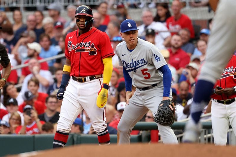 Braves right fielder Ronald Acuna, left, takes a lead next to Los Angeles Dodgers first baseman Freddie Freeman at Truist Park Friday, June 24, 2022, in Atlanta. (Jason Getz / Jason.Getz@ajc.com)