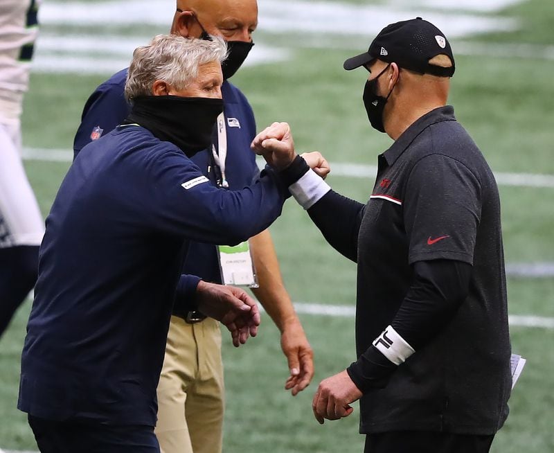 091320 Atlanta: Atlanta Falcons head coach Dan Quinn and Seattle Seahawks head coach Pete Carroll give each other a fist-bump after the Seahawks beat the Falcons 38-25 in the season opener Sunday, Sept. 13, 2020, in Atlanta.  (Curtis Compton / Curtis.Compton@ajc.com)
