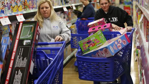 Nov. 27, 2015 - Atlanta - Stacy Levine (left) and Melissa Bragg look for deals at Toys"R"Us Friday morning. The cousins shop together every year, and started shopping at 5:30 AM. Black Friday shoppers look for bargains at the Toys"R"Us store in Atlanta. The store opened on Thanksgiving day, and stayed open all night and all day Friday. According to store manager Travis Stephens, about two hundred shoppers were lined up for the Thursday opening. Additional Friday "door buster" deals kicked in at 7am on Friday, bringing in more early morning shoppers. BOB ANDRES / BANDRES@AJC.COM