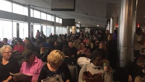 Passengers wait to exit Concourse C around 4 p.m. Sunday, Dec. 17, 2017, after power at Hartsfield-Jackson International Airport had been out for about three hours. (Photo by Rick Crotts / AJC)