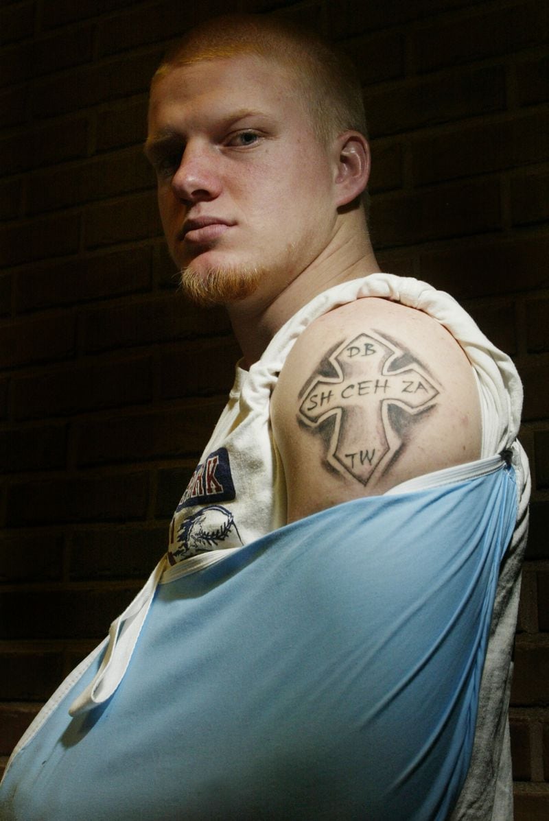 A.J. Ranthum poses with his new tattoo in memory of his 5 teammates who died in the bus crash in Atlanta. Staff Photo by Teesha McClam
