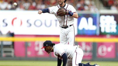 ATLANTA, GA - JUNE 15:  Shortstop Dansby Swanson #7 of the Atlanta Braves throws to first base over second baseman Ozzie Albies #1 during the game against the San Diego Padres at SunTrust Park on June 15, 2018 in Atlanta, Georgia.  (Photo by Mike Zarrilli/Getty Images)