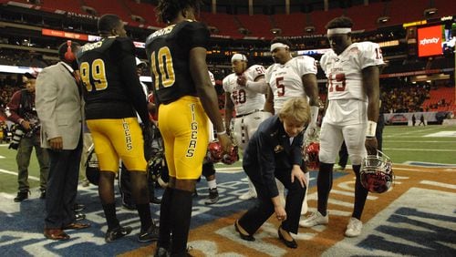 MEAC champs North Carolina Central goes up against SWAC champs Grambling State in the Air Force Reserve Celebration Bowl at the Georgia Dome in Atlanta. Lt. General Mary Ann Miller retrieves the coin that has just been flipped signaling the start of the game. (W.A. Bridges Jr./Special to the AJC)