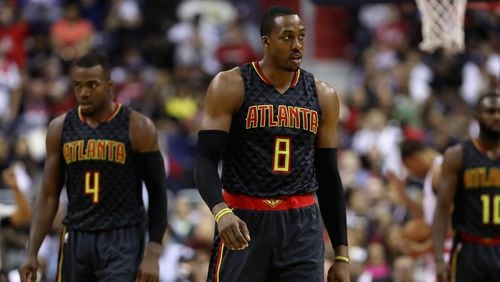 Dwight Howard (8) and Paul Millsap (4) of the Atlanta Hawks walk off the floor during the timeout in the first half against the Washington Wizards in Game 2 of the Eastern Conference Quarterfinals during the 2017 NBA Playoffs at Verizon Center on April 19, 2017 in Washington, DC. (Photo by Rob Carr/Getty Images)