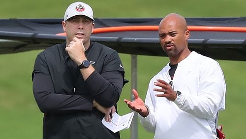 Falcons head coach Arthur Smith (left) and general manager Terry Fontenot (right) confer during team practice at mini-camp on Wednesday, Jun 10, 2021, in Flowery Branch.