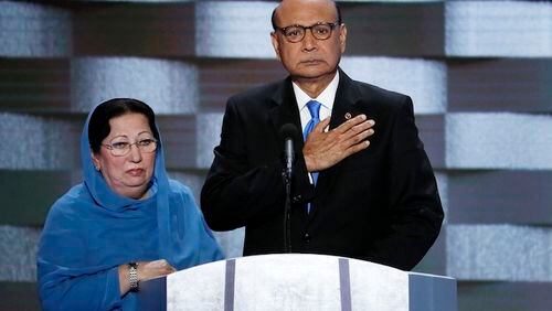 FILE - In this Thursday, July 28, 2016 file photo, Khizr Khan, father of fallen US Army Capt. Humayun S. M. Khan and his wife Ghazala speak during the final day of the Democratic National Convention in Philadelphia. Republican presidential nominee Donald Trump broke a major American political and societal taboo over the weekend when he engaged in an emotionally-charged feud with Khizr and Ghazala Khan, the bereaved parents of a decorated Muslim Army captain killed by a suicide bomber in Iraq. He further stoked outrage by implying Ghazala Khan did not speak while standing alongside her husband at last week's Democratic convention because they are Muslim. (AP Photo/J. Scott Applewhite, File)