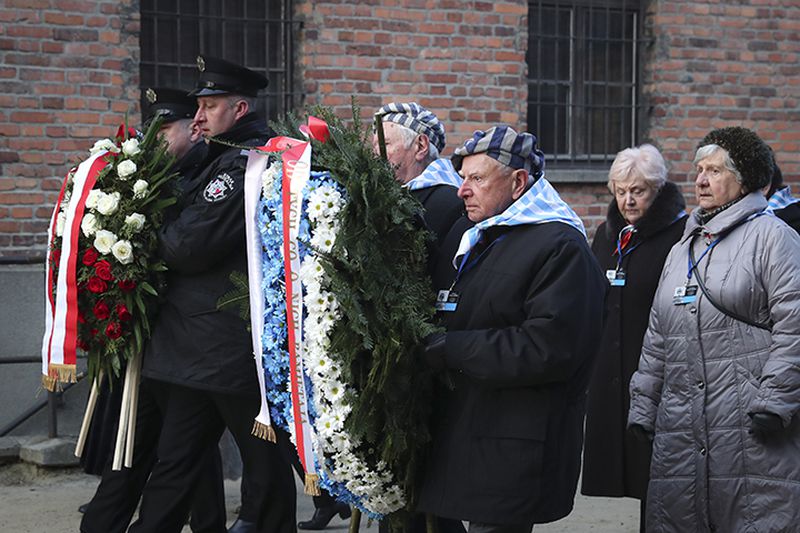 Survivors carry a wreath Monday at the Auschwitz Nazi death camp in Oswiecim, Poland.