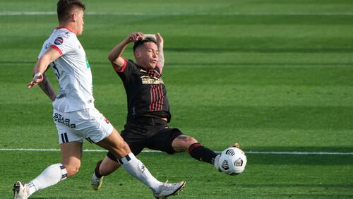 Atlanta United Ezequiel Barco (8) tries to get the ball past LD Alajuelense Fern��n Faerron (3) during the first half of a CONCACAF Champions League soccer match on Tuesday, April 13, 2021, in Atlanta. (AP Photo/Ben Gray)