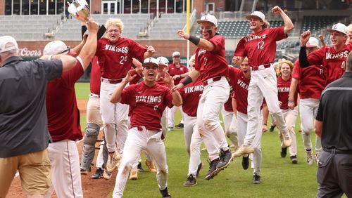 Lowndes players celebrate their 5-2 win against Parkview in game two to win the GHSA baseball 7A state championship at Truist Park, Wednesday, May 17, 2023, in Atlanta. Lowndes won the GHSA baseball 7A state championship series 2-0. (Jason Getz / Jason.Getz@ajc.com)