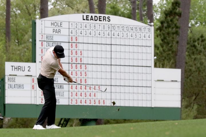 April 10, 2021, Augusta: With the leaderboard in the background, Justin Rose hits his fairway shot on the third hole during the third round of the Masters at Augusta National Golf Club on Saturday, April 10, 2021, in Augusta. Curtis Compton/ccompton@ajc.com