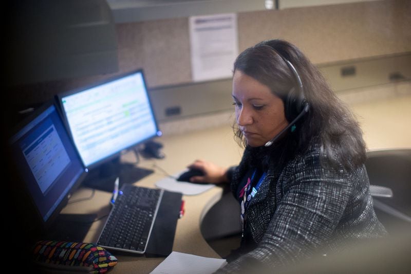Responder Carolina Roy works at her desk at the VA’s crisis hotline call center in Atlanta, Tuesday, Dec. 13, 2016. BRANDEN CAMP / SPECIAL