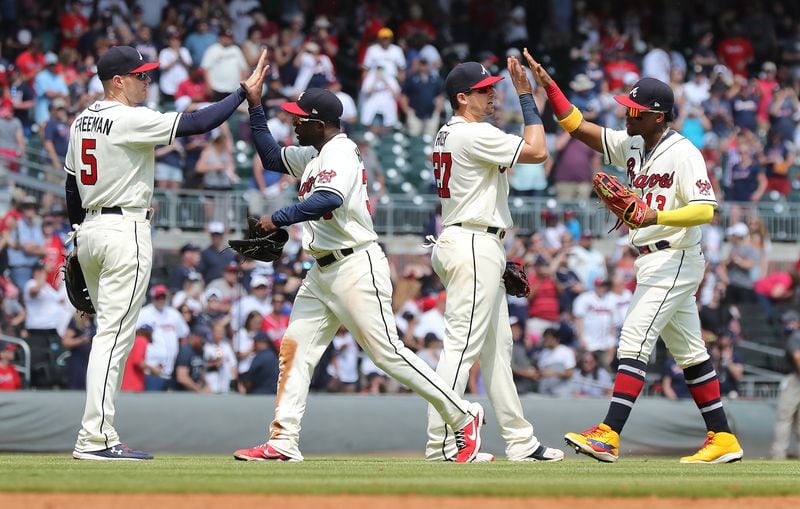 Braves players Freddie Freeman (from left), Guillermo Heredia, Austin Riley and Ronald Acuna celebrate a 7-1 victory over the Pittsburgh Pirates Sunday, May 23, 2021, at Truist Park in Atlanta. (Curtis Compton / Curtis.Compton@ajc.com)