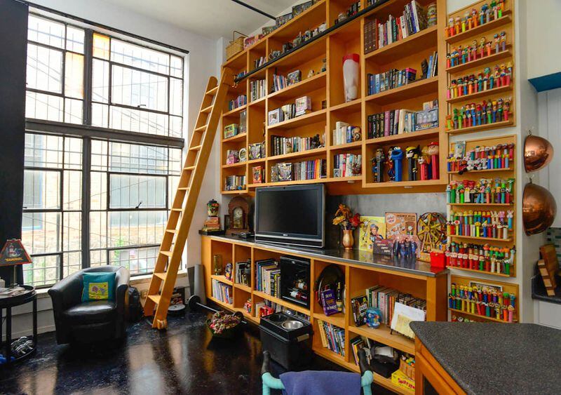 The loft is an eclectic escape from the hustle and bustle of downtown Atlanta. This custom shelving unit displays some of the couple's most interesting memorabilia, which can be seen on the Oct. 14 Castleberry Hill Loft Tour.