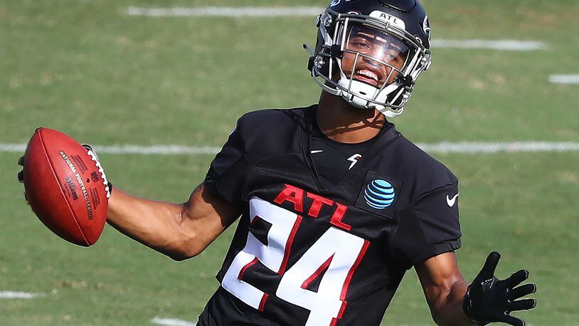 Falcons rookie cornerback A.J. Terrell comes up with the pick while running a defensive drill during training camp practice Thursday, Aug. 27, 2020, in Flowery Branch.