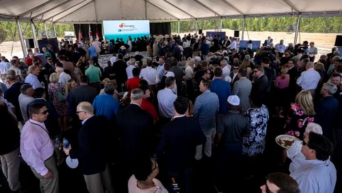 People gather under a tent on Friday, May 20, 2022 for an announcement at the site where South Korean automotive giant Hyundai Motor Group will build an electric vehicle plant in Ellabell, Ga. It is the second major electric vehicle factory announcement in Georgia since December as state economic development officials try to turn the Peach State into an important manufacturing hub for battery-powered automobiles. (AJC Photo/Stephen B. Morton)