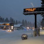 
                        A sign announces snow closures in South Lake Tahoe, Calif., on Saturday, March 2, 2024. Thousands of residents were left without power and life came to a standstill for many in the Sierra Nevada region on Saturday after a winter storm dumped as much as two feet of snow overnight. (David Calvert/The New York Times).
                      