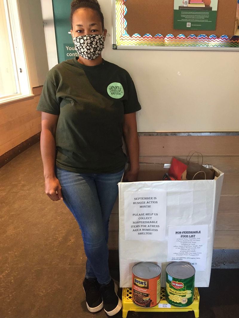 Store manager Lucretia Cooper stands next to last month’s food drive bin in Starbucks on Oct. 15, 2021. She corresponds the items of the drive with the most prominent needs of homeless people. Courtesy of Destiny Johnson
