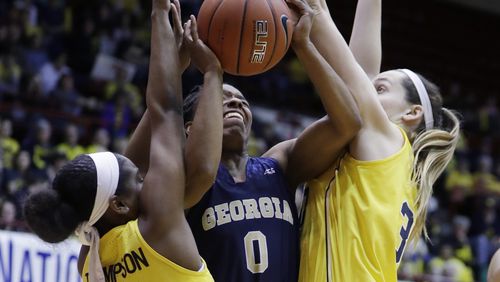 Georgia Tech guard Imani Tilford (0) attempts a shot defended by Michigan guard Siera Thompson (2) and center Hallie Thome (30) during the first half of the WNIT Championship college basketball game, Saturday, April 1, 2017, in Detroit. (AP Photo/Carlos Osorio)