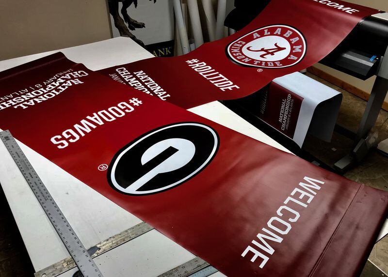 Some Georgia businesses have found ways to profit from the college football national championship between Georgia and Alabama. Kay Roberts of Kay’s Signs said her company was contracted to make hundreds of street banners in Atlanta for the game. Photo courtesy of Kay’s Signs.