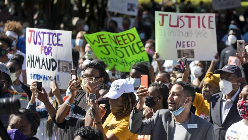 People react during a rally to protest the shooting of Ahmaud Arbery, an unarmed black man Friday, May 8, 2020, in Brunswick Ga. Two men have been charged with murder in the February shooting death of Arbery, whom they had pursued in a truck after spotting him running in their neighborhood. (AP Photo/John Bazemore)