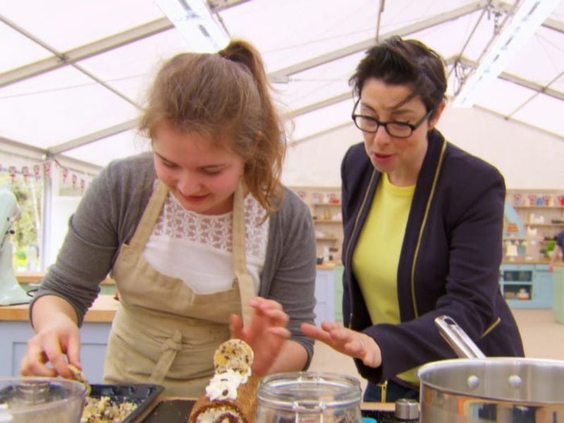 Quarterfinalist Martha Collison (left), seen with co-host Sue Perkins, was 17 when she competed on “The Great British Baking Show,” making her the youngest ever of the show’s bakers. (Courtesy of BBC)