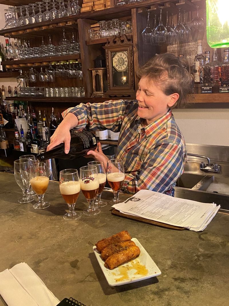 Molly Gunn pours a vintage bottle of Allagash Interlude Belgian-style ale at the Porter Beer Bar in Little Five Points.