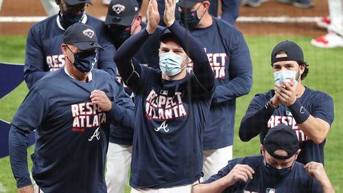 A strange look from a strange season: Masked Braves celebrate clinching another National League East title last Tuesday. (Curtis Compton/Atlanta Journal-Constitution/TNS)