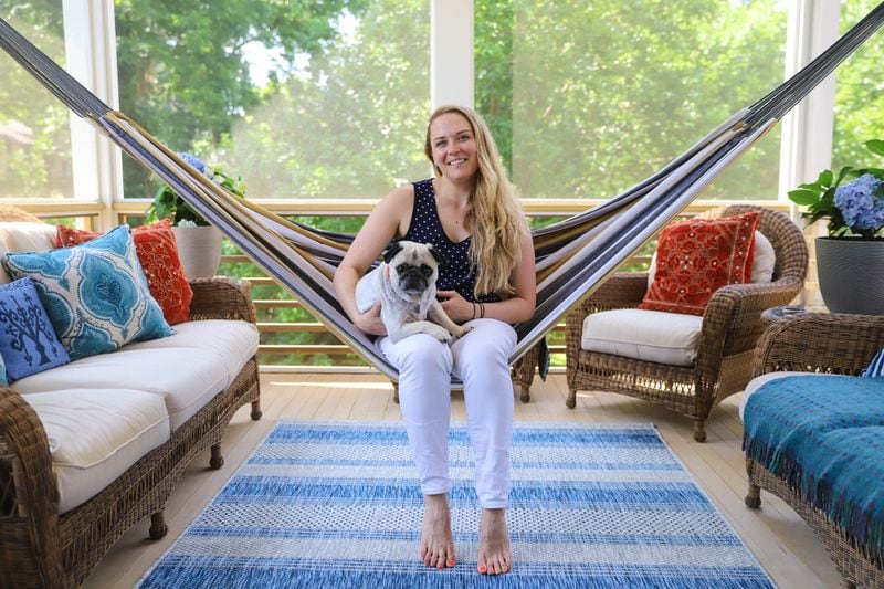 Emi Piez, an executive assistant for Portman Holdings, with her pug, Henry, purchased the home in Atlanta's West End neighborhood in 2016. The hammock, a gift, is one of the homeowner's favorite places to sit when hanging out with her friends and family.