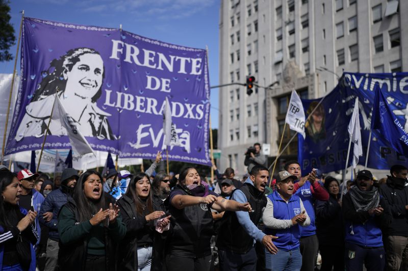 Anti-government protesters march against food scarcity at soup kitchens and against economic reforms proposed by President Javier Milei in Buenos Aires, Argentina, Wednesday, April 10, 2024. (AP Photo/Natacha Pisarenko)