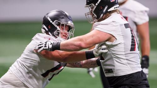 Falcons offensive lineman Jalen Mayfield, left, and Kaleb McGary, right, participate in a drill together during minicamp at Mercedes-Benz Stadium, Tuesday, June 13, 2023, in Atlanta. (Jason Getz / Jason.Getz@ajc.com)