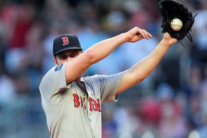 Boston Red Sox pitcher Kutter Crawford (50) wipes his face in the third inning of a baseball game against the Atlanta Braves Tuesday, May 7, 2024, in Atlanta. (AP Photo/John Bazemore)