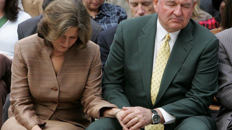 Georgia Gov. Sonny Perdue and his wife Mary pray during a prayer service for rain on the steps of the Capitol Tuesday, Nov. 13, 2007. "We've come together here simply for one reason and one reason only: To very reverently and respectfully pray up a storm," Perdue said. The state's appeal to God for rain showers came as Georgia is mired in an epic drought, threatening the region's water supply. (AP Photo/John Bazemore)