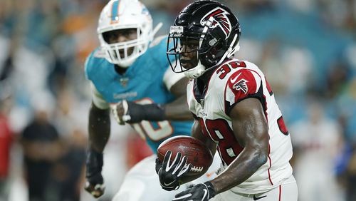 Kenjon Barner #38 of the Atlanta Falcons runs with the ball after a reception against the Miami Dolphins during the second quarter of the preseason game at Hard Rock Stadium on August 08, 2019 in Miami, Florida. (Photo by Michael Reaves/Getty Images)