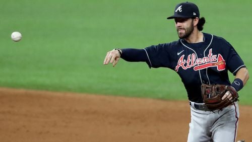 Braves shortstop Dansby Swanson throws to first base to complete the double play during the fifth inning of Game 7 of the National League Championship Series Sunday, Oct. 18, 2020, at Globe Life Field in Arlington, Texas. (Curtis Compton / Curtis.Compton@ajc.com)