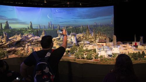 Fans get a preview of Stars Wars: Galaxy&apos;s Edge, a new area under construction at Disneyland. the model was shown at the D23 Expo in July. (Gina Ferazzi/Los Angeles Times/TNS)