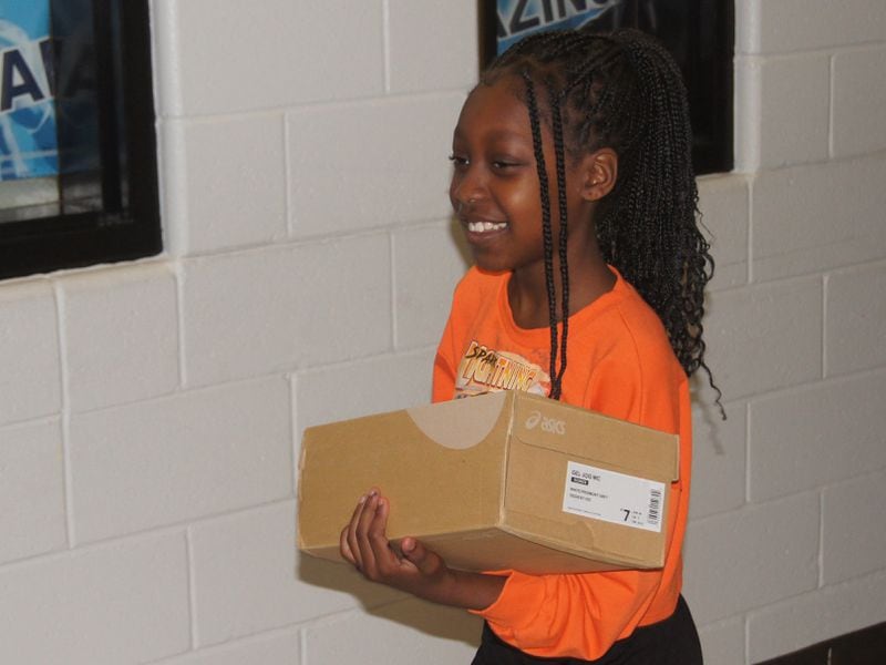 Students were all smiles after receiving a gift of a new pair of tennis shoes Friday afternoon. (Photo Courtesy of Bob Pepalis)