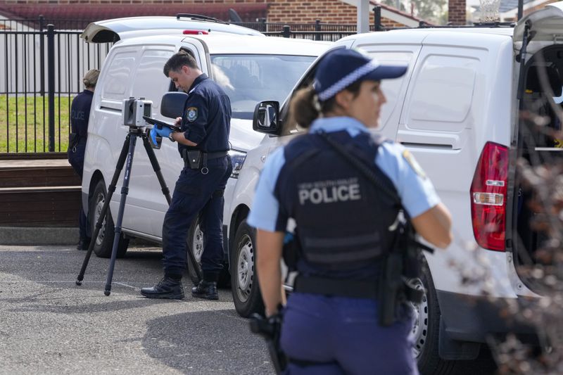A police forensic officer works at a crime scene at the Christ the Good Shepherd Church in suburban Wakely in western Sydney, Australia, Tuesday, April 16, 2024. Australian police say a knife attack in Sydney that wounded a bishop and a priest during a church service as horrified worshippers watched online and in person, and sparked a riot was an act of terrorism. (AP Photo/Mark Baker)