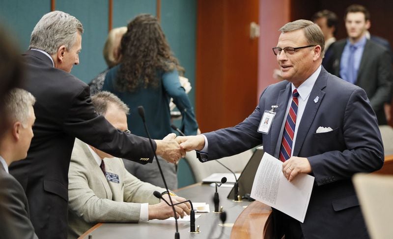 Mike Griffin (right), a lobbyist for the Georgia Baptist Mission Board, greets members of the state Senate Judiciary Committee before a hearing on Senate Bill 375, the Keep Faith in Adoption and Foster Care Act. BOB ANDRES /BANDRES@AJC.COM
