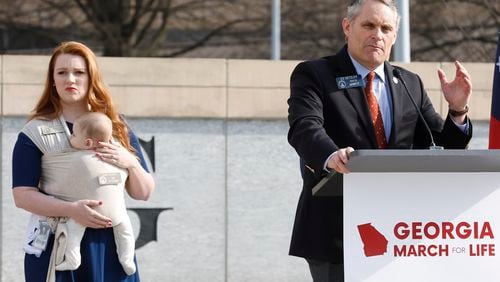 State Rep. Lauren Daniel, R-Locust Grove, holds her baby Zane as state Sen. Ed Setzler, R-Acworth, speaks during an anti-abortion "March for Life" rally in February. Republican lawmakers have pushed a variety of legislation they say is aimed at helping families, mothers and children since passing a restrictive abortion law in 2019 that Setzler sponsored. (Natrice Miller / natrice.miller@ajc.com)