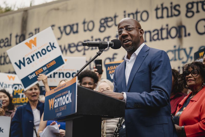 Sen. Raphael Warnock, D-Ga., speaks by a mural of John Lewis in Atlanta, as Georgia’s Senate election headed to a runoff contest, on Nov. 10, 2022. neither Senate candidate cleared 50% of the vote, triggering the Dec. 6 matchup. “You have to admit that I did warn y’all that we might be spending Thanksgiving together,” Warnock said. “And here we are.” (Nicole Craine/The New York Times)