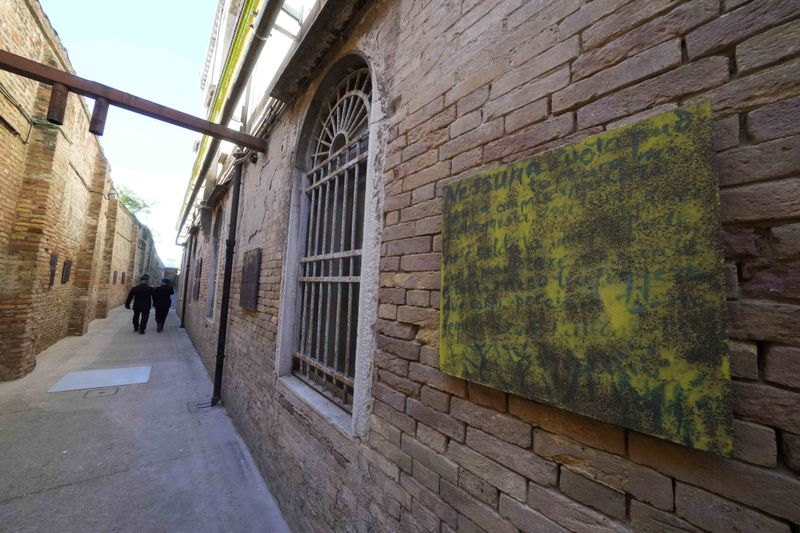 An installation by artist Simone Fattal is displayed inside the women's prison at the Giudecca island during the 60th Biennale of Arts exhibition in Venice, Italy, Wednesday, April 17, 2024. A pair of nude feet dirty, wounded and vulnerable are painted on the façade of the Venice women's prison chapel, the work of Italian artist Maurizio Cattelan and part of the Vatican's pavilion at the Venice Biennale in an innovative collaboration between inmates and artists. (AP Photo/Luca Bruno)