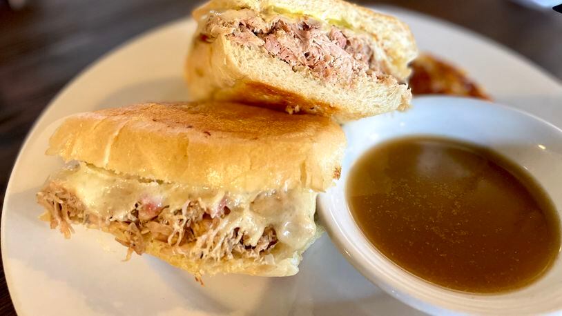 The Cuban sandwich at Rico’s World Kitchen trades the traditional roasted pork and ham combo for marinated and smoked chicken. Angela Hansberger for The Atlanta Journal-Constitution