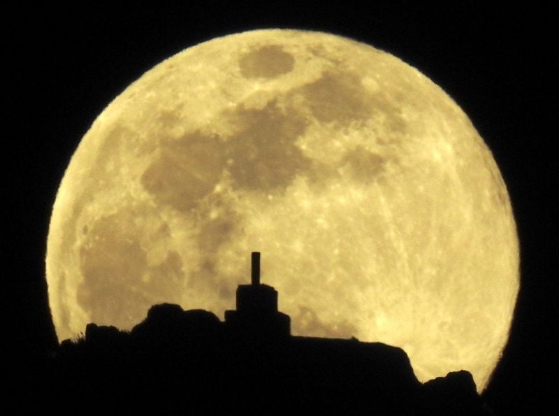 A view of the full moon over Mount Pico Sacro, just outside Santiago de Compostela, Spain.