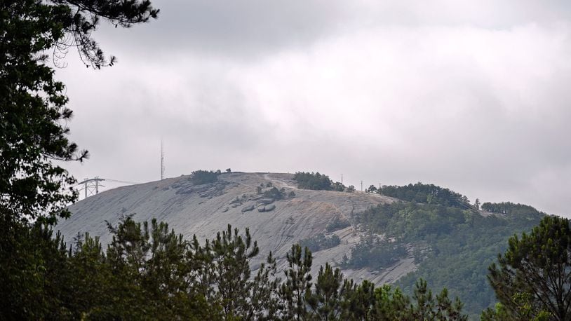 Clouds in the morning light partially obscure a radio tower atop Stone Mountain in this 2015 file photo.
