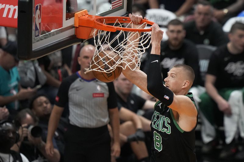 Boston Celtics forward Kristaps Porzingis (8) dunks the ball during the first half of Game 3 of an NBA basketball first-round playoff series against the Miami Heat, Saturday, April 27, 2024, in Miami. (AP Photo/Wilfredo Lee)