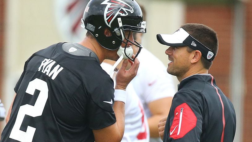 Falcons quarterbacks coach Matt LaFleur confers with Matt Ryan during a team practice in 2015. (Curtis Compton/AJC)