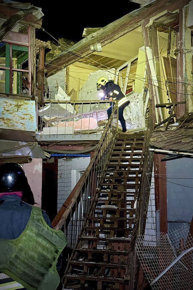 In this photo provided by the Mayor of Odesa Hennadii Trukhanov in Telegram, firefighters work on the site of a damaged building after a Russian drone attack in Odesa, Ukraine, Tuesday, April 23, 2024. (Mayor of Odesa Hennadii Trukhanov via AP)