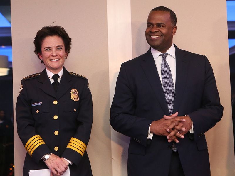 Atlanta Chief of Police Erika Shields shares a laugh with Mayor Kasim Reed during her oath of office ceremony last year. In a statement, Shields said it was a “reasonable assist” for members of her department’s Executive Protection Unit to pick up the mayor’s meals and dry cleaning. She did not respond to a question about the appropriatness of the officers using city-issued credit cards to do so. CURTIS COMPTON/CCOMPTON@AJC.COM