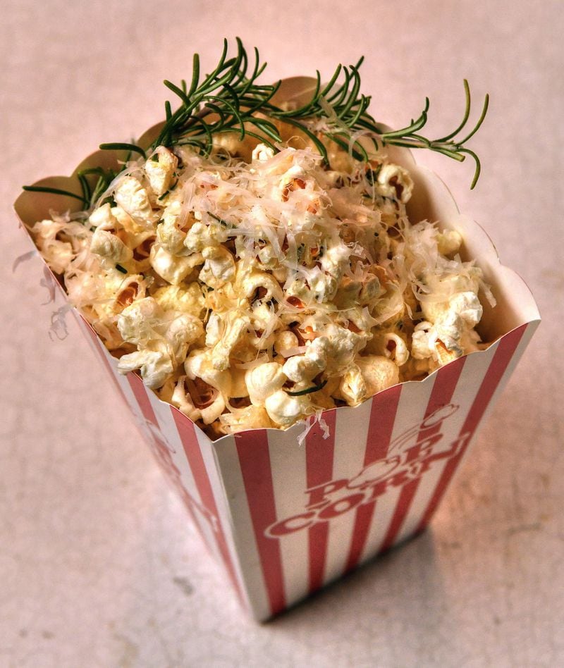Give your evening a gourmet twist with Olive Oil Popcorn with Garlic, Rosemary, and Parmesan. (Styling by Susan Puckett / Chris Hunt for the AJC)