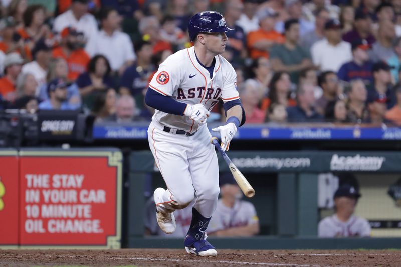 Houston Astros' Alex Bregman flips his bat as he heads to first base for an RBI single against the Atlanta Braves during the fifth inning of a baseball game Wednesday, April 17, 2024, in Houston. (AP Photo/Michael Wyke)